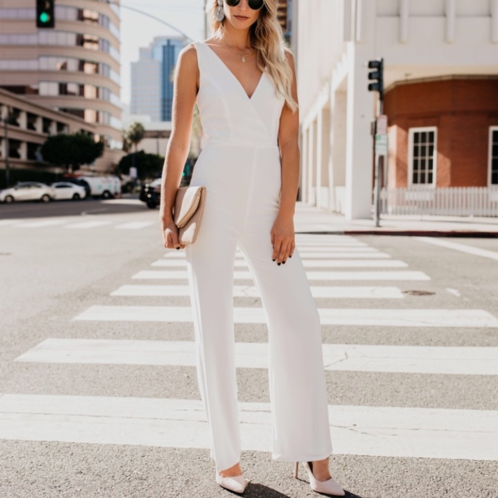 VICI white jumpsuit with V-neck top and wide leg.